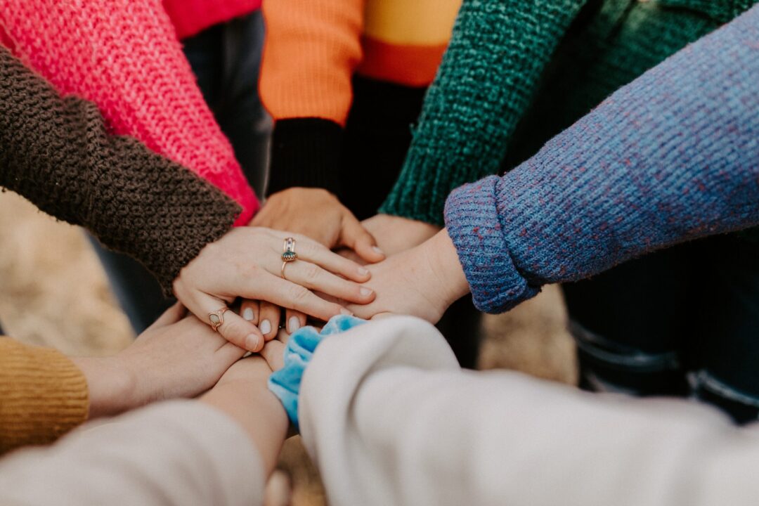 Hands overlapping as a gesture of support.