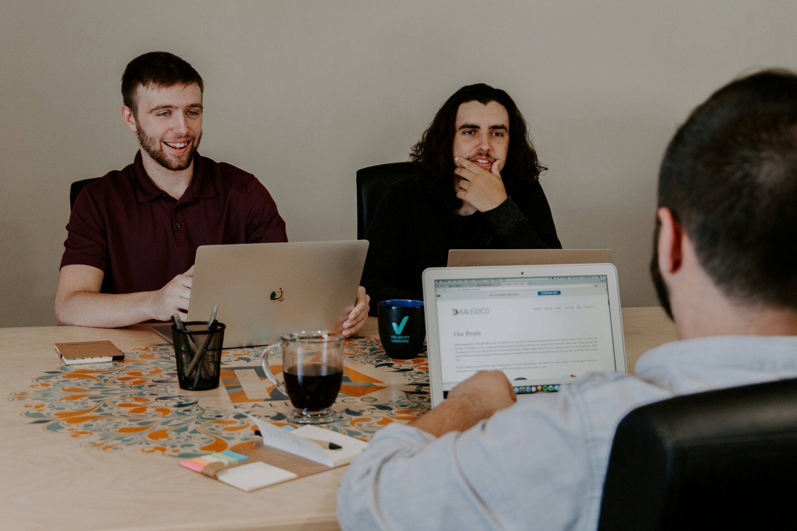 image of students using laptops at a table.