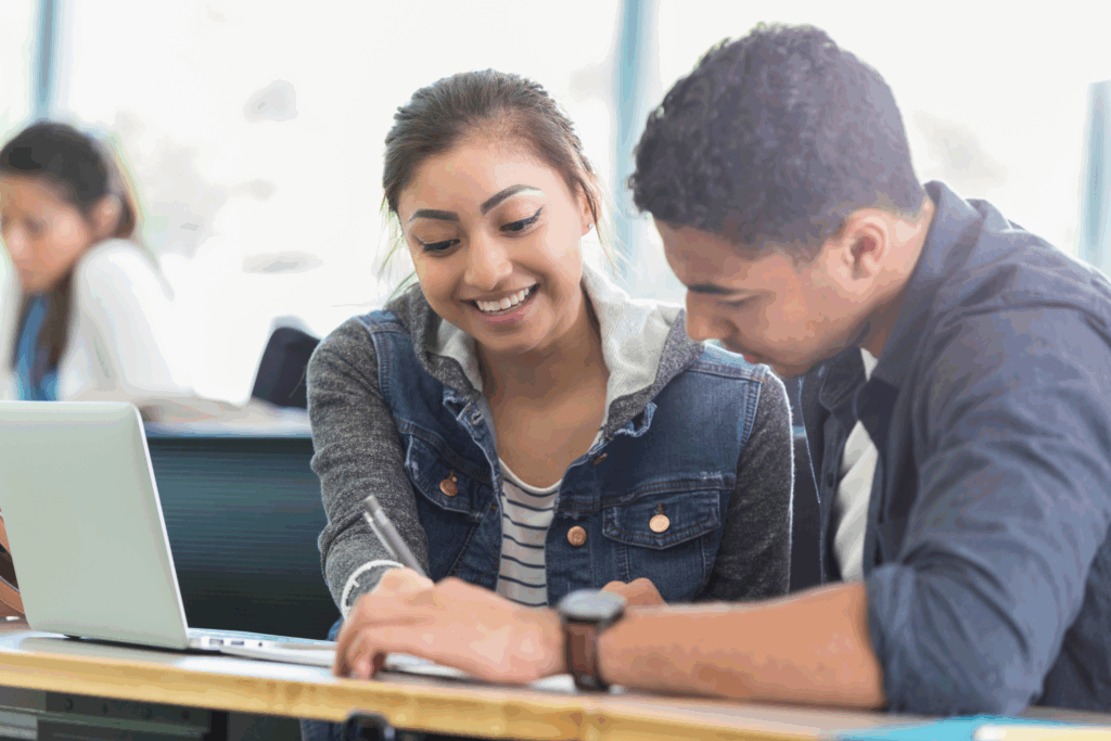 Two students working together in a classroom.
