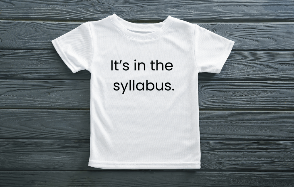 A white t-shirt with the text "It's in the syllabus" printed on the front.