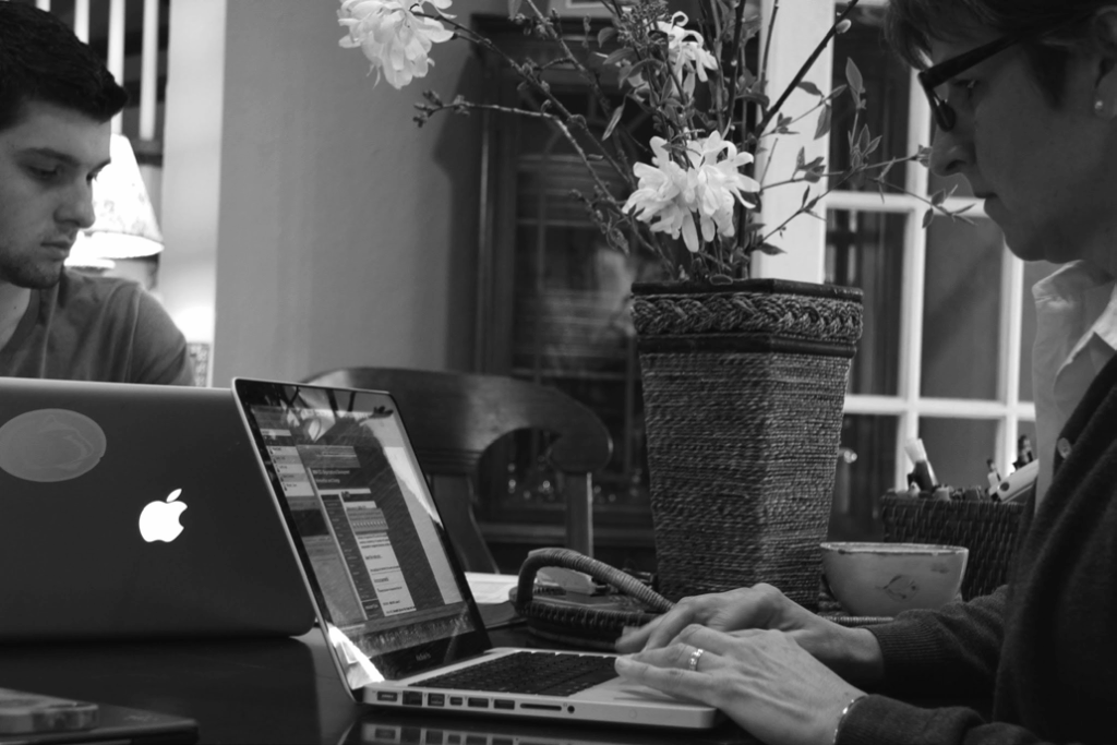 An online faculty member typing on a laptop.