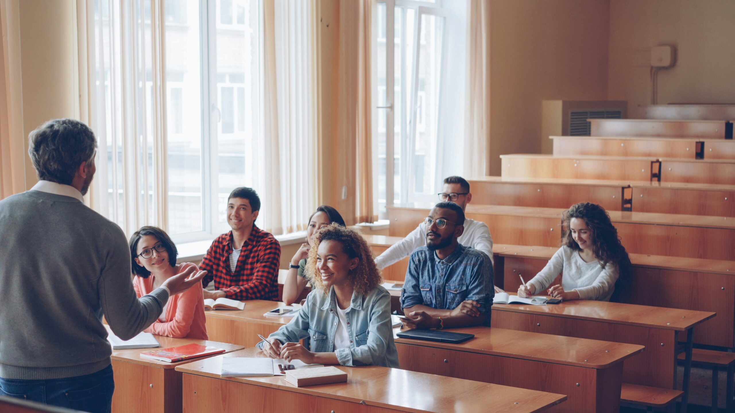 Students in rows facing an instructor at the front of the classroom.