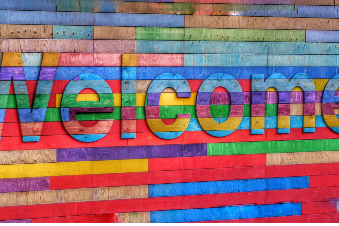 A colorful sign with the word "Welcome " prominently displayed.